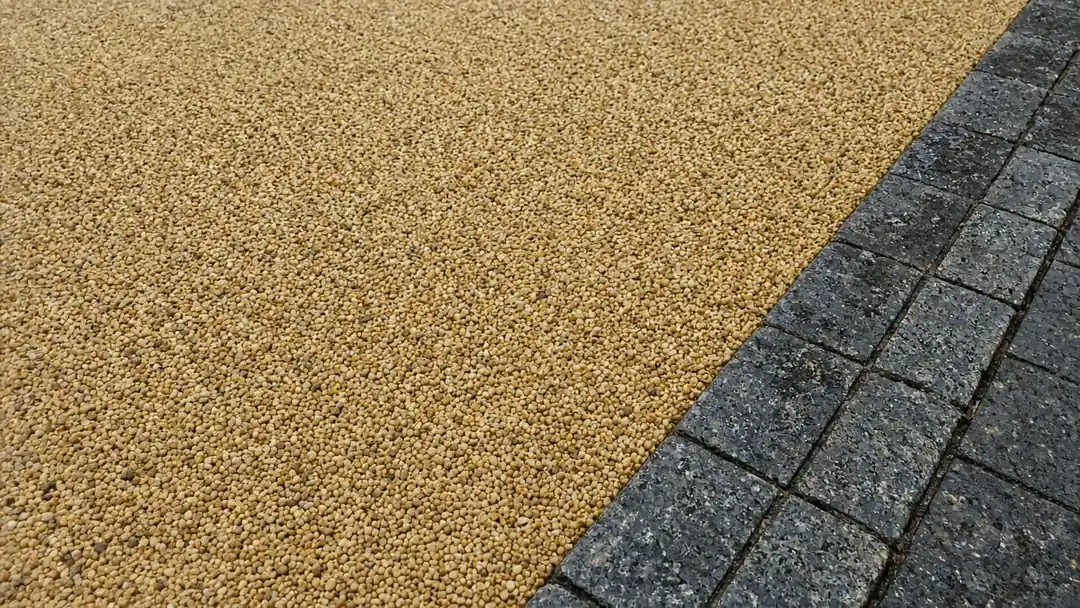 Example image: close-up of a resin-bound stone surface beside metal edging